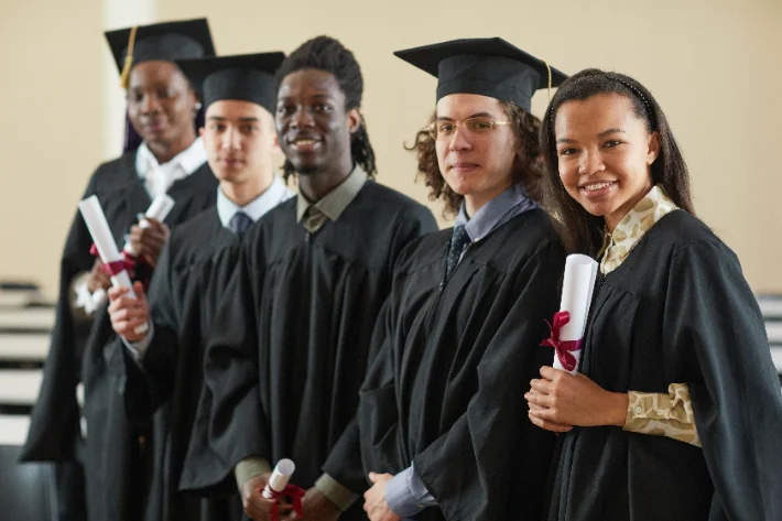 Graduation — gowns and proud hugs